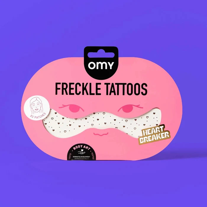 Packaging of freckle tattoos with OMY branding on a purple background