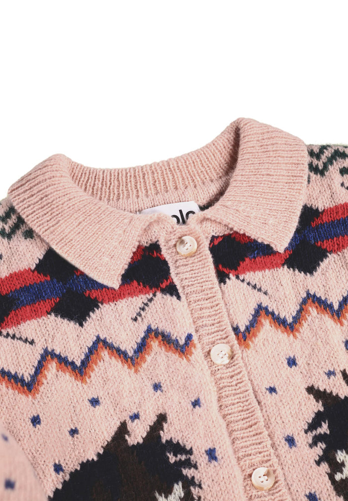 Close-up of a pink cardigan with patterned design on a white background