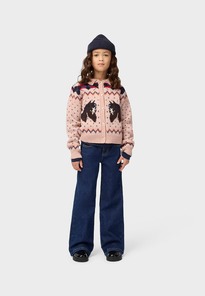 Child wearing pink sweaters and wide leg jeans