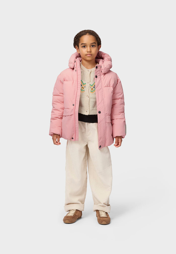 Child wearing a pink puffer jacket on a white background