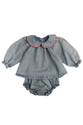 A baby girl's denim two-piece outfit featuring a long-sleeve top with a Peter Pan collar trimmed in red and a matching ruffled bloomers, laid flat on a white background.