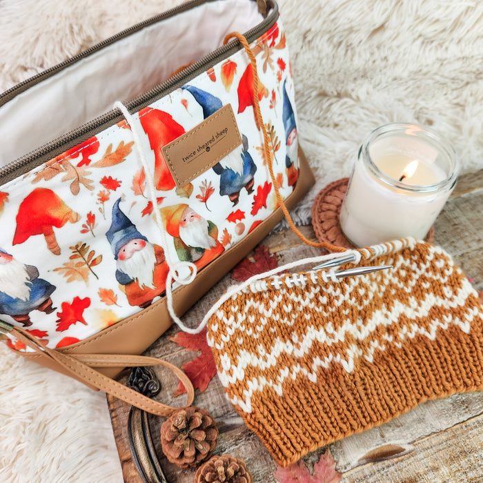 Gnome Friends Trinity Bag open showing white lining with colorwork knitting project, candle, and autumn decor