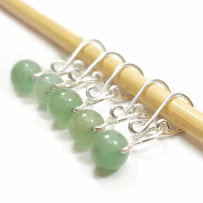 Five green aventurine bead melody ring removable stitch markers with silver hooks on bamboo knitting needle