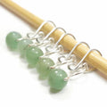 Five green aventurine bead melody ring removable stitch markers with silver hooks on bamboo knitting needle