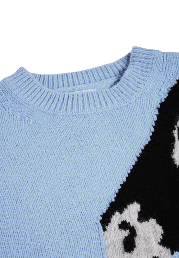 Light blue sweater with a black and white pattern on a white background
