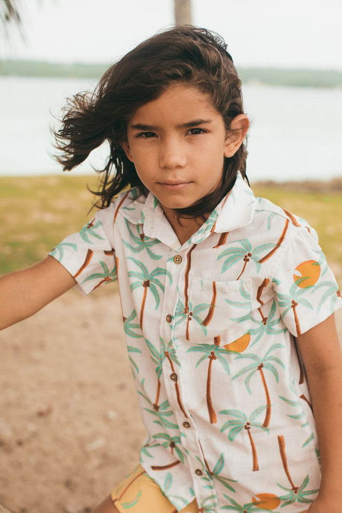 Child wearing a patterned shirt outdoors