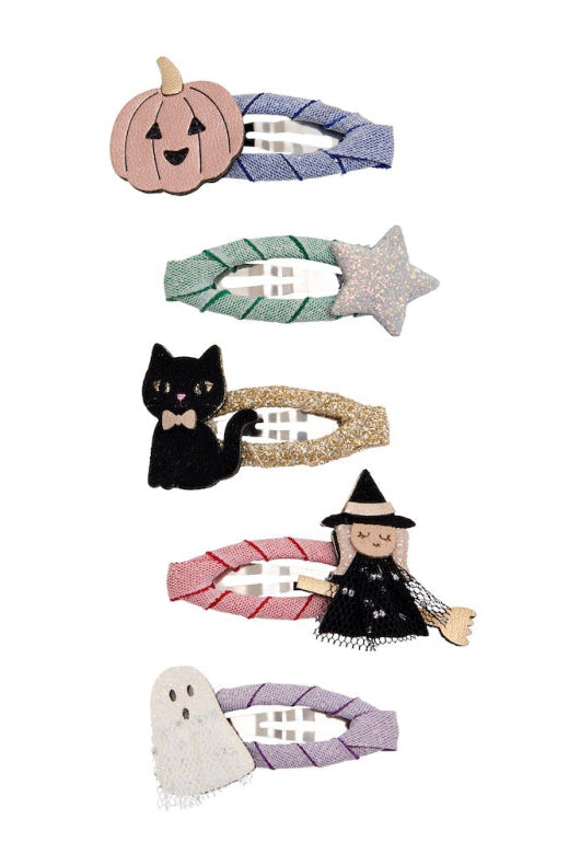 Six Halloween-themed fabric hair clips arranged vertically on a white background, featuring a jack-o'-lantern, green star, black cat, pink witch, and ghost designs.