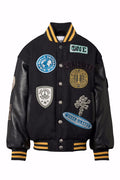 Black varsity jacket with various patches on a white background