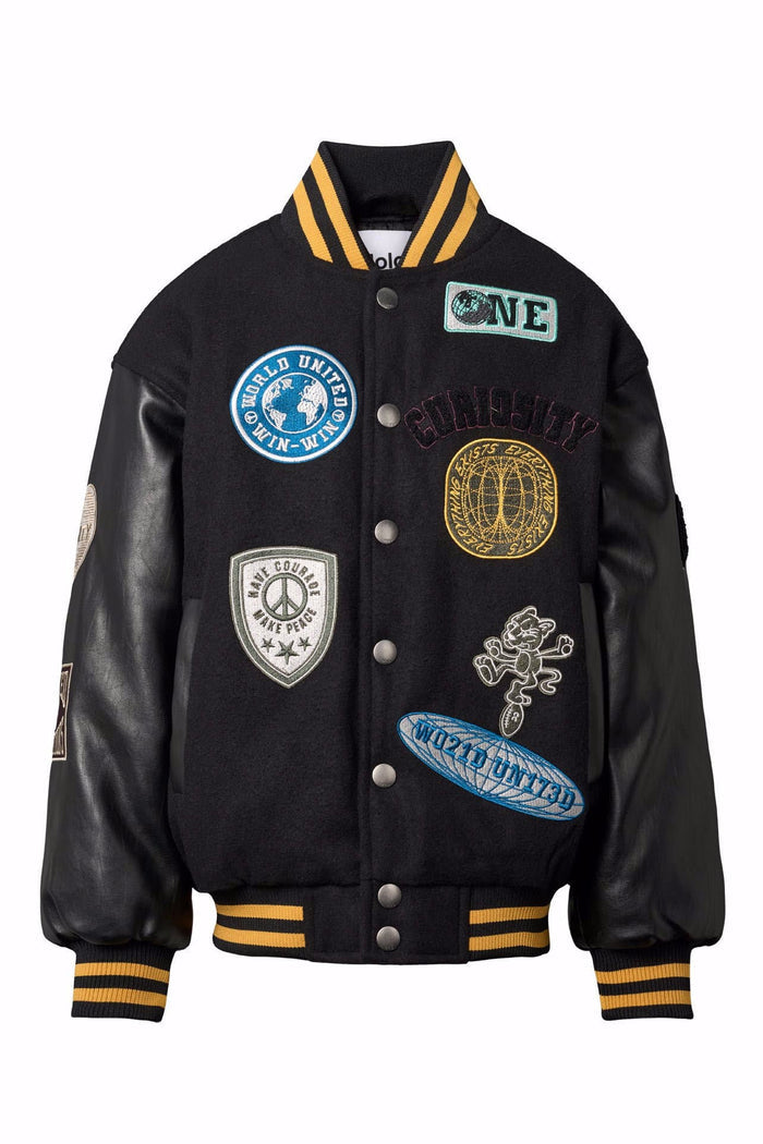 Black varsity jacket with various patches on a white background