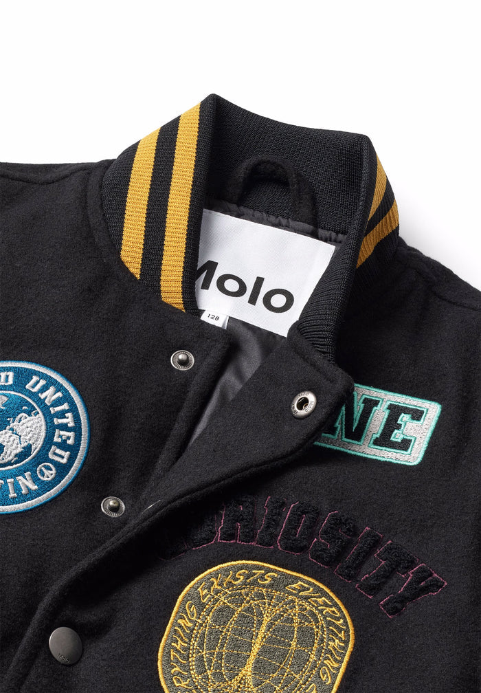 Black varsity jacket with embroidered logos and a visible Molo label on a white background