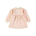 A long-sleeve baby dress in a light pink and white checkered pattern with small yellow star accents, featuring ruffled shoulder details and a gathered waist, shown against a plain white background.