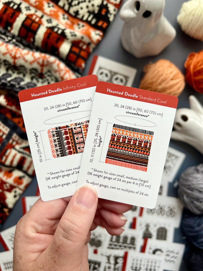 Hand holding the Haunted Doodle Infinity Cowl and Standard Cowl schematic cards