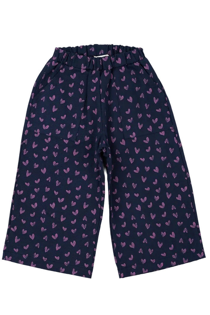 Navy blue pants with pink heart pattern on a white background