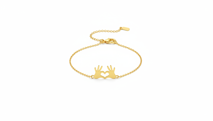 Gold chain bracelet featuring a central charm of two hands forming a heart shape, isolated on a white background.