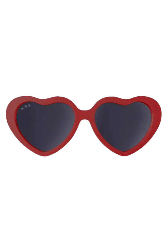 Heart-shaped sunglasses with red frames on a white background
