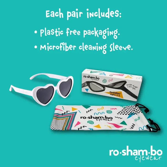 Heart-shaped sunglasses with packaging and cleaning sleeve on a teal background, featuring ro-sham-bo eyewear branding.