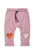 Pink knit pants for toddlers featuring an orange embroidered heart on the left leg and a white embroidered heart on the right leg, with a dark purple drawstring waistband.