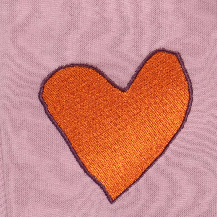 Orange heart-shaped patch on a pink background