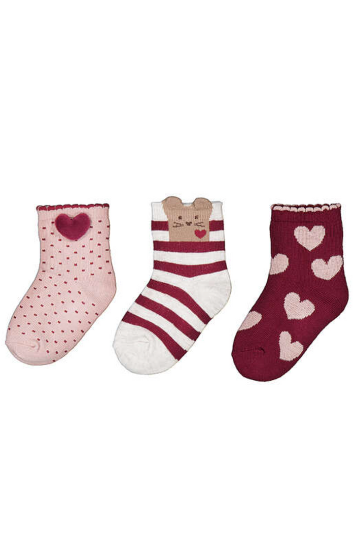 Three pairs of children's socks with heart patterns on a white background