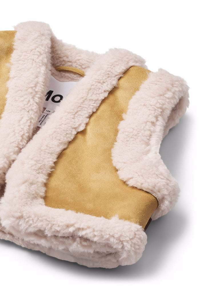 Beige vest with white sherpa lining on a white background