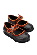 Black shoes with orange straps on a white background