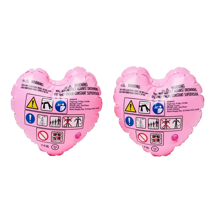 Two pink heart-shaped arm bands with safety symbols on a white background