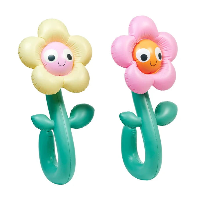 Two inflatable flower-shaped toys with smiling faces on a white background