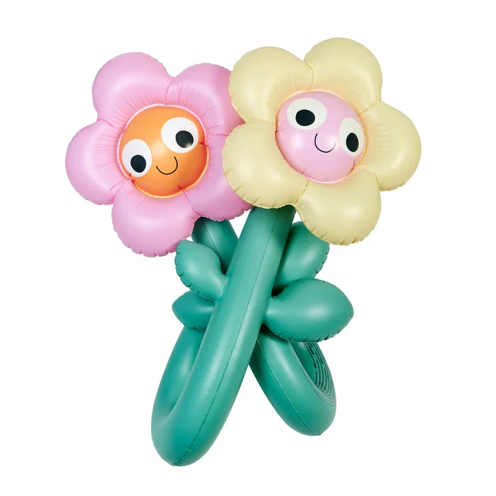Two colorful flower-shaped toys with smiling faces on a white background