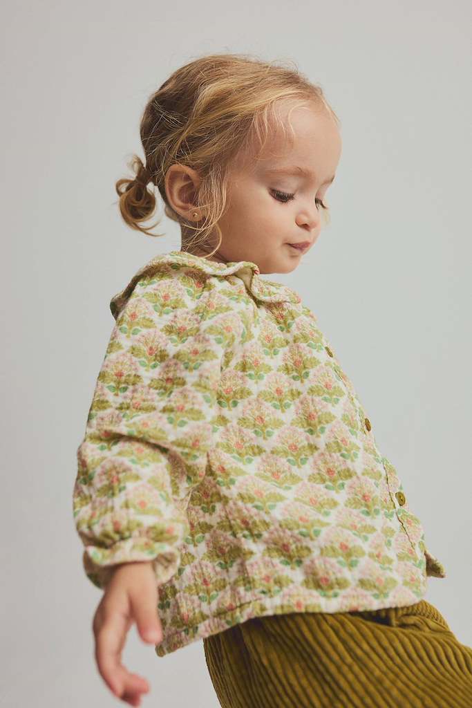 child wearing green floral blouse