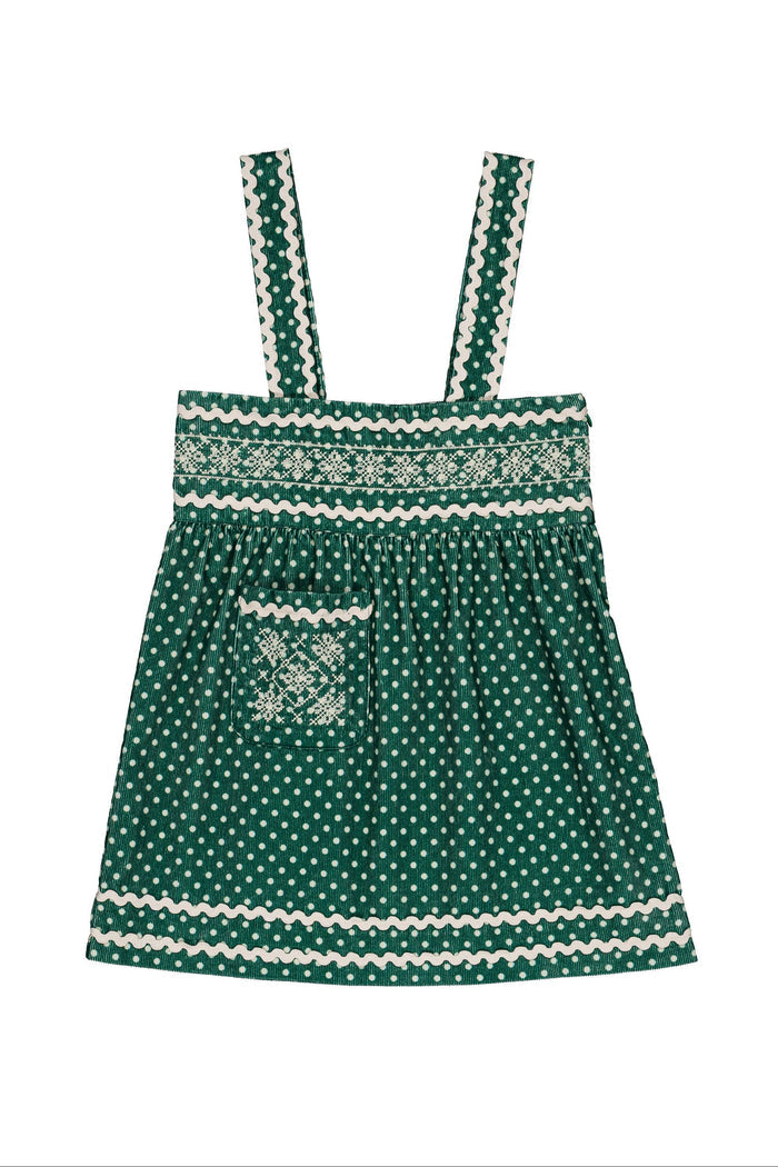 A green and white patterned  dress with thin shoulder straps, a smocked front, and a front pocket, shown against a plain white background.