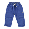 Blue corduroy pants for baby, featuring an elastic waistband with a white drawstring, large front patch pockets, and a small brand label on the left hip.
