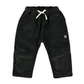 graphite colored corduroy pants on a white backgroung