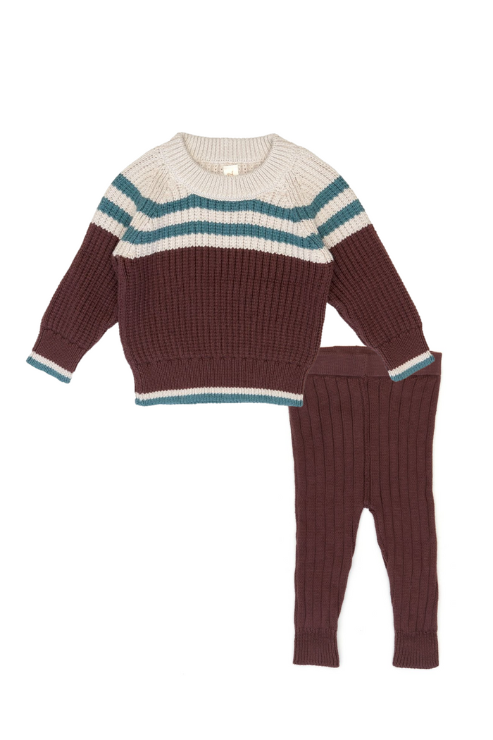 Knitted sweater and leggings set with horizontal stripes on a white background