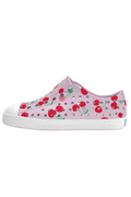 Pink children's shoe with cherry design on a white background