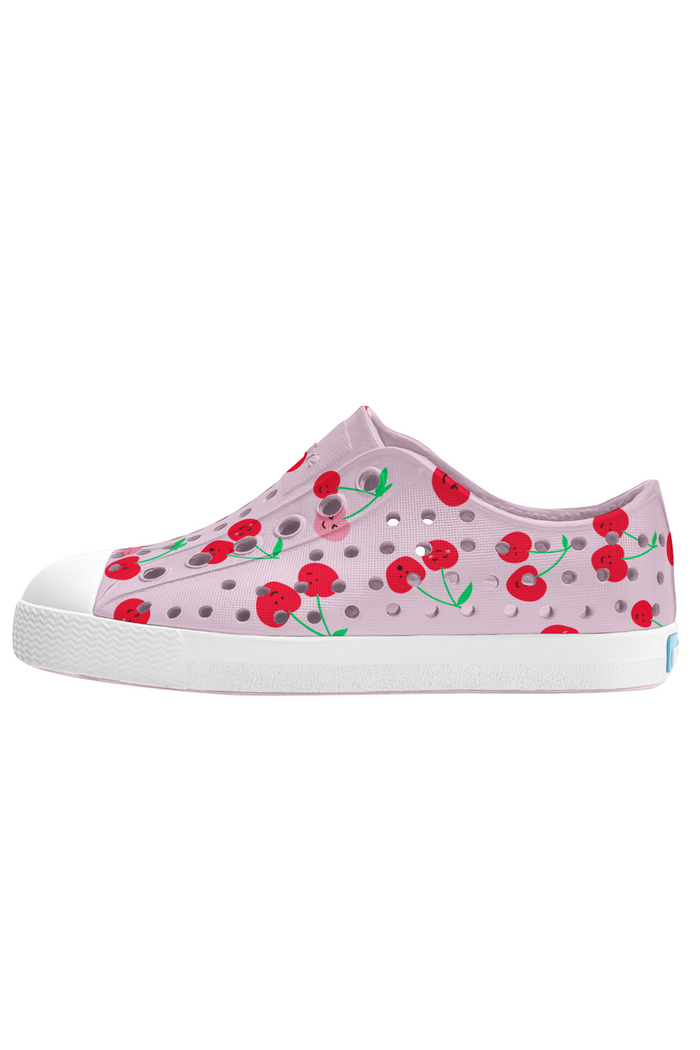 Pink children's shoe with cherry design on a white background