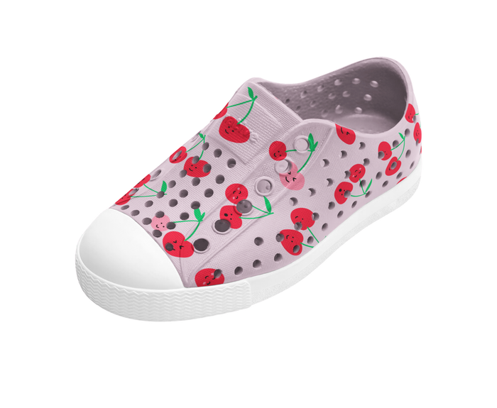 Children's shoe with cherry pattern on a white background
