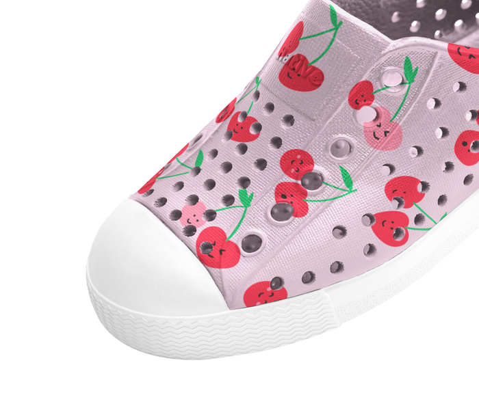 Pink slip-on shoe with cherry pattern on a white background