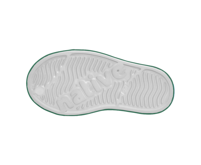 White sole of a shoe with green rim on a white background