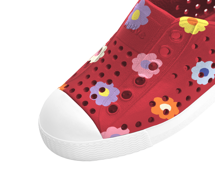 Red children's shoe with floral patterns on a transparent background