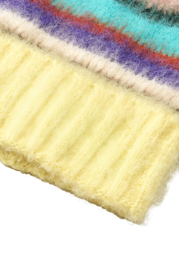 Close-up of a yellow knitted fabric with colorful border