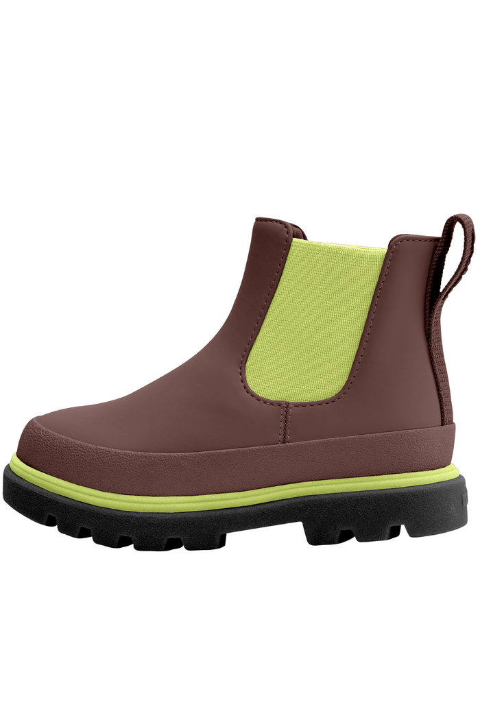 Brown boot with a green patch on a white background