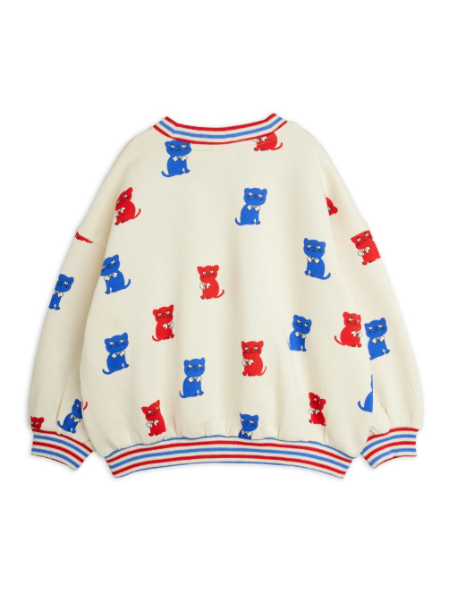 White sweater with red and blue kitten pattern on a white background