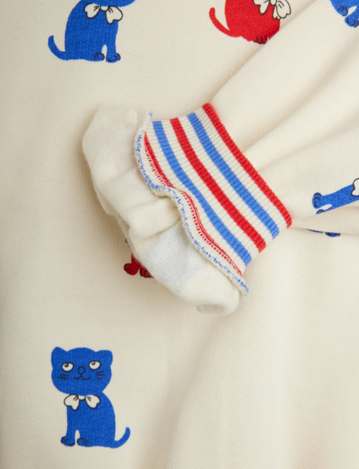 White sweater with red and blue kitten pattern on a white background