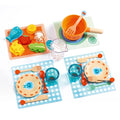 felt food on placemats with wooden utensils and dinnerware on white background