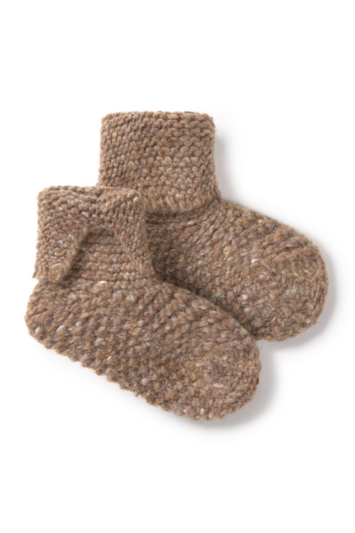 Pair of brown knitted baby socks on a white background
