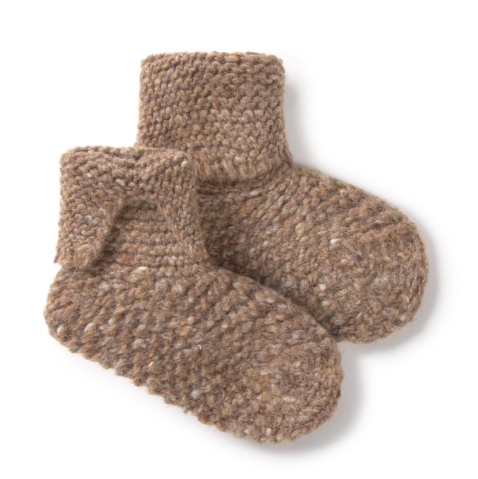 Pair of brown knitted booties on a white background