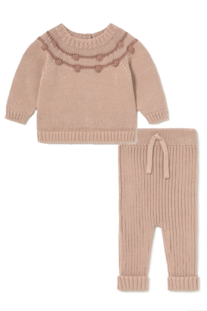 Knitted sweater and pants set in beige on a white background