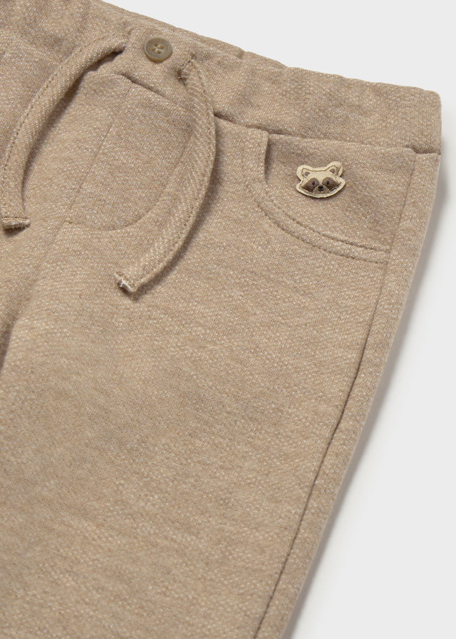 Close-up of beige pants on a white background