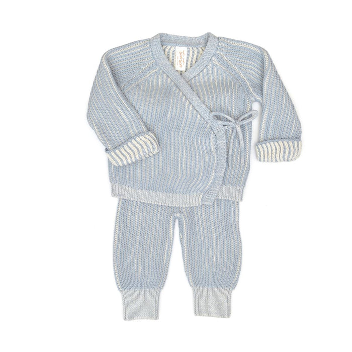 Knitted baby outfit with cardigan and pants on a white background