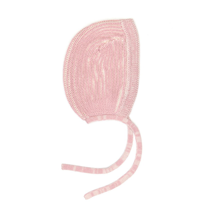 Pink knitted baby bonnet on a white background
